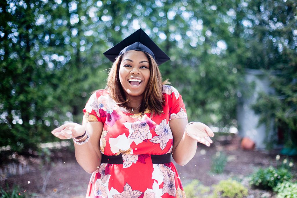 A happy college graduate who successfully transferred colleges to receive the highest education she could before entering the workforce.